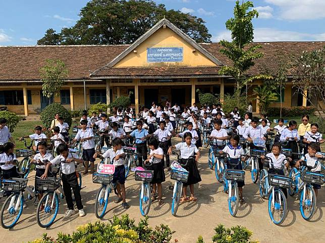 Students receive bikes donated by Chinese Hello Inc. at a primary school in Kampong Thom province, Cambodia on Dec. 23, 2024. (Photo by Van Pov/Xinhua)