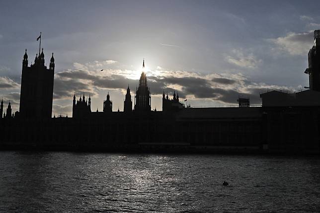 The sun sets behind the Houses of Parliament in London. Nearly half of Britons support allowing Hongkongers with British overseas passports live in Britain, a survey found. Photo: AP