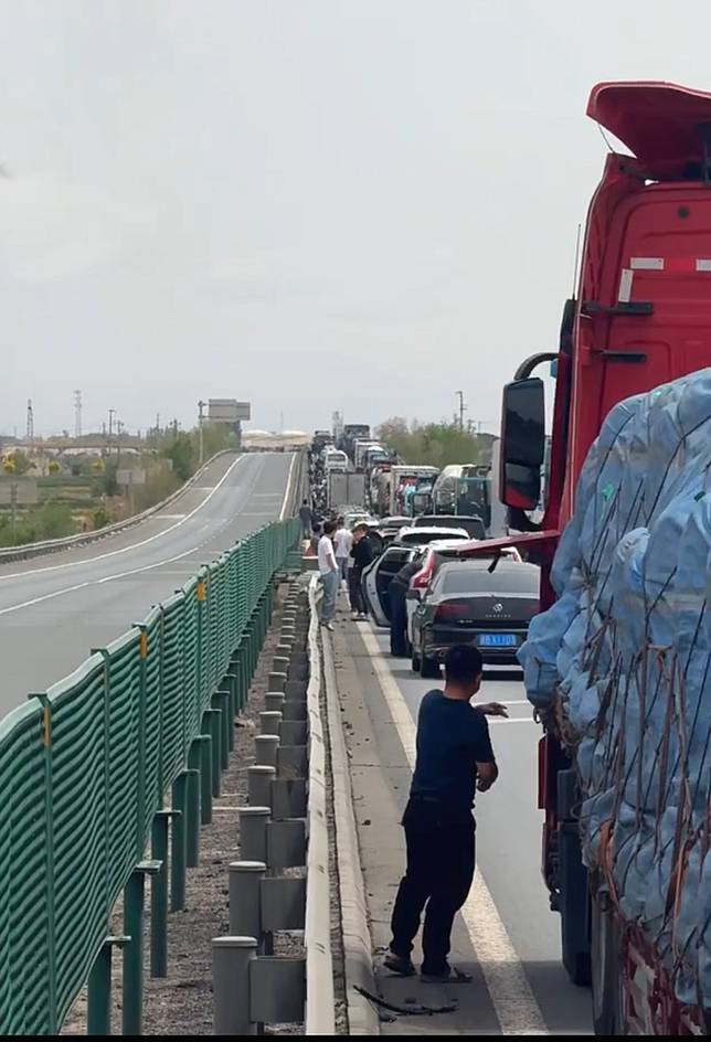 中國五一長假期間，有民眾在高速公路上大塞車，期間透過手機點外賣解飢，真有餐廳老闆娘親自送餐。翻攝瀟湘晨報