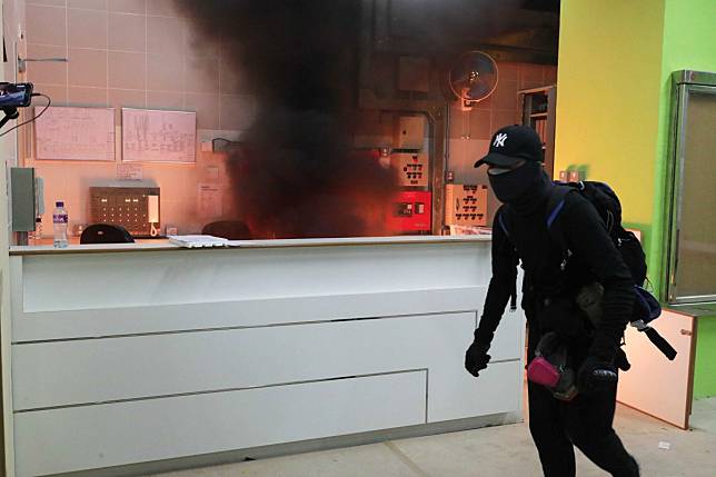 A masked man dressed in black tossed a petrol bomb igniting a fire in the lobby of the Fanling public housing estate the government suggested could serve as a quarantine site for Wuhan coronavirus. Photo: Edmond So