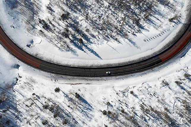 An aerial drone photo taken on Jan. 25, 2025 shows a vehicle running on the Yaxue Road in northeast China's Heilongjiang Province. (Xinhua/Xie Jianfei)