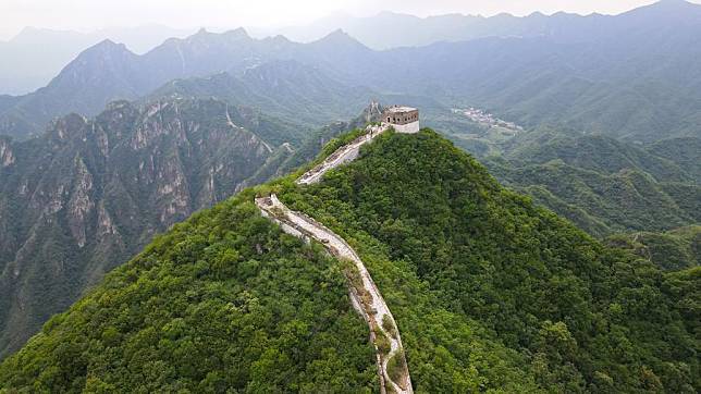 An aerial drone photo shows walls to be restored near a defense tower of the Jiankou section of the Great Wall in Beijing, capital of China, July 1, 2024. (Xinhua/Chen Zhonghao)