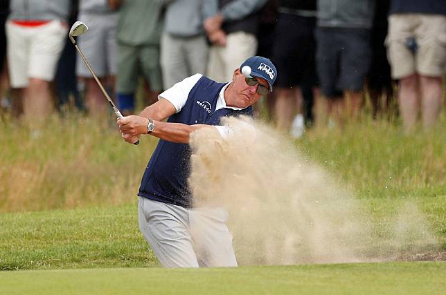 FILE PHOTO: Phil Mickelson plays out of a bunker during the 149th Open Championship