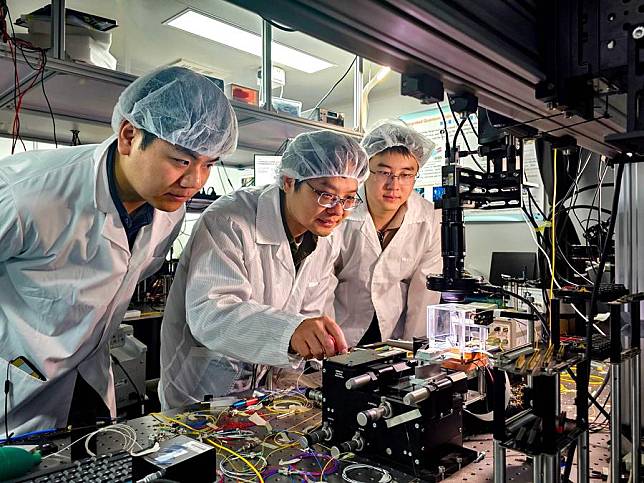 Wang Jianwei &copy;, a professor at Peking University, tests an integrated photonic quantum chip with doctoral students Jia Xinyu (L) and Zhai Chonghao in a laboratory of Peking University in Beijing, capital of China, Feb. 18, 2025. (Xinhua)