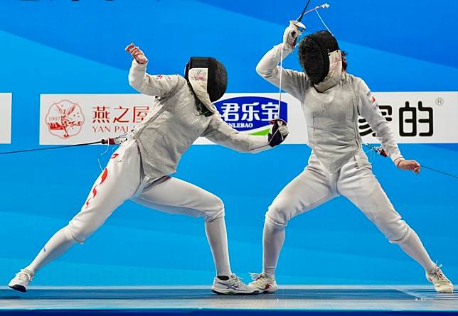 Wang Yuting &reg; vies with Jiao Enqi in women's foil at the 2024 National Fencing Champions Tournament (second leg) in Qingyuan, Guangdong Province, June 3, 2024 (Photo by Ni Minzhe/Xinhua)