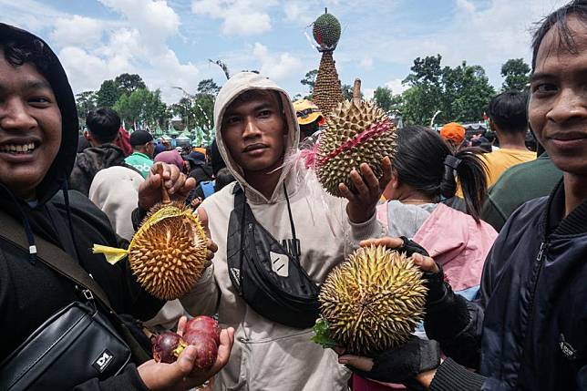 People take part in a durian feast held as a tradition for farmers after harvest in Wonosalam of Jombang district in East Java, Indonesia, March 5, 2023. (Photo by Sahlan Kurniawan/Xinhua)