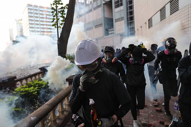 Masked radicals try to leave Polytechnic University on Monday morning. Photo: Sam Tsang