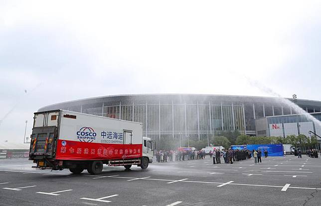 A truck loaded with exhibits for the upcoming 7th China International Import Expo (CIIE) is greeted with a water salute during an accession ceremony for exhibits at the National Exhibition and Convention Center (Shanghai), the main venue for the CIIE, in east China's Shanghai, Oct. 22, 2024. (Xinhua/Fang Zhe)