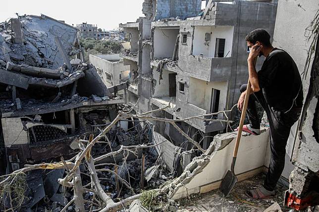 A man views houses destroyed by an Israeli airstrike in the al-Bureij refugee camp of the central Gaza Strip, on Nov. 17, 2024. (Photo by Rizek Abdeljawad/Xinhua)