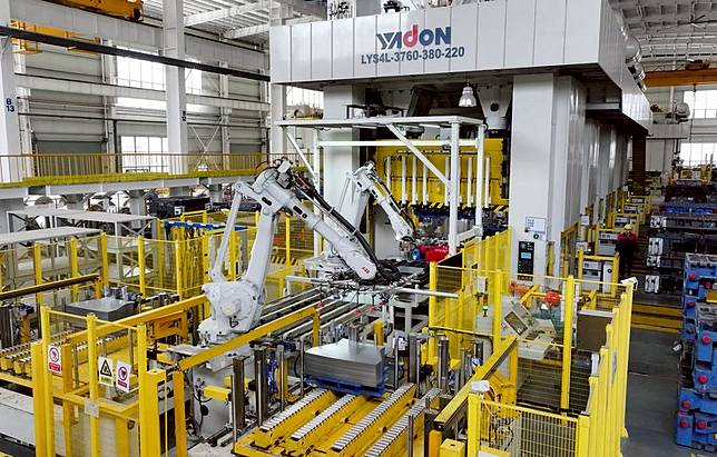 Robotic arms operate at a workshop of an auto parts manufacturing company in Feixi County of Hefei, east China's Anhui Province, March 31, 2025. (Photo by Xu Yong/Xinhua)