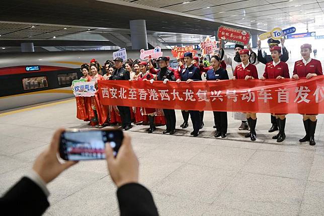 Train attendants of a high-speed train service from Xi'an to Hong Kong pose for a photo at Xi'an North Railway Station in Xi'an, northwest China's Shaanxi Province, Jan. 5, 2025. (Xinhua/Li Yibo)