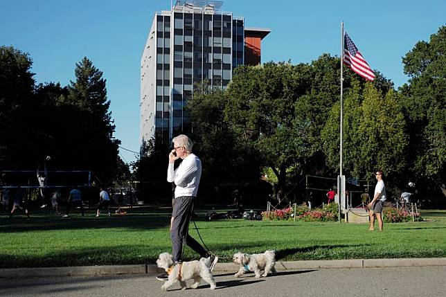 A man walks dogs in a park in San Mateo, California, the United States, June 14, 2021. (Xinhua/Wu Xiaoling)