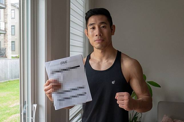 Jeff Chan poses with his One Championship contract. Photo: MMAShredded
