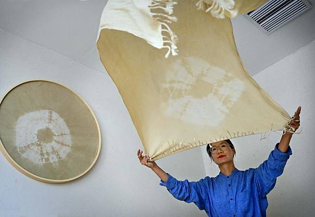 Wang Danfeng arranges dyed cloth bedding at a homestay in Luanchuan County of Luoyang, central China's Henan Province, Sept. 13, 2024. (Xinhua/Li An)