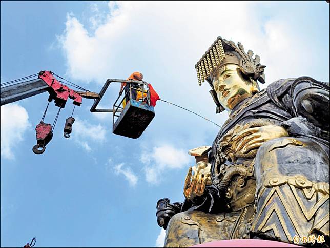 道士乘坐吊臂車的吊籃升空，在媽祖神像前進行開光安座儀式。(記者佟振國攝)