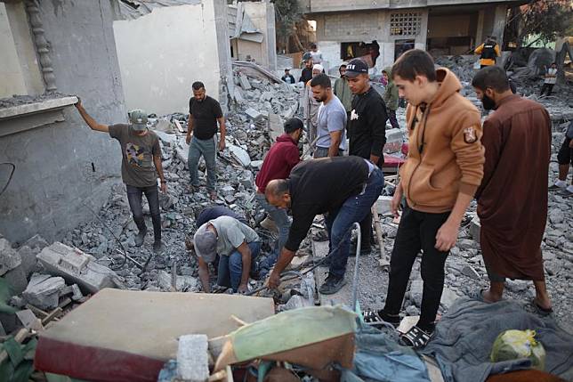 People search among the rubble of a building destroyed in an Israeli airstrike in the Nuseirat camp, central Gaza Strip, on Nov. 7, 2024. (Marwan Dawood/Xinhua)